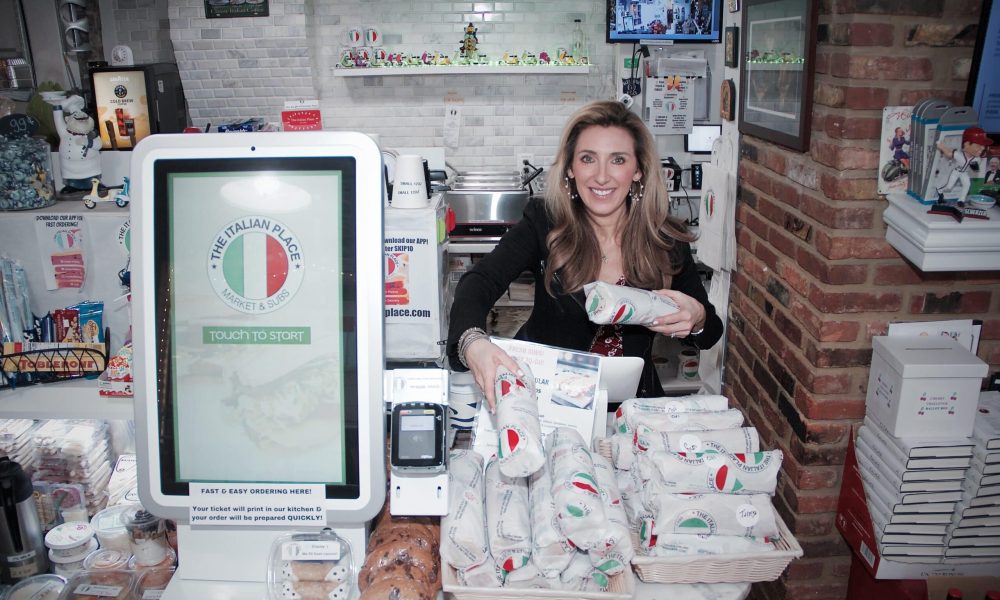 The Italian Place register and founder with sandwiches